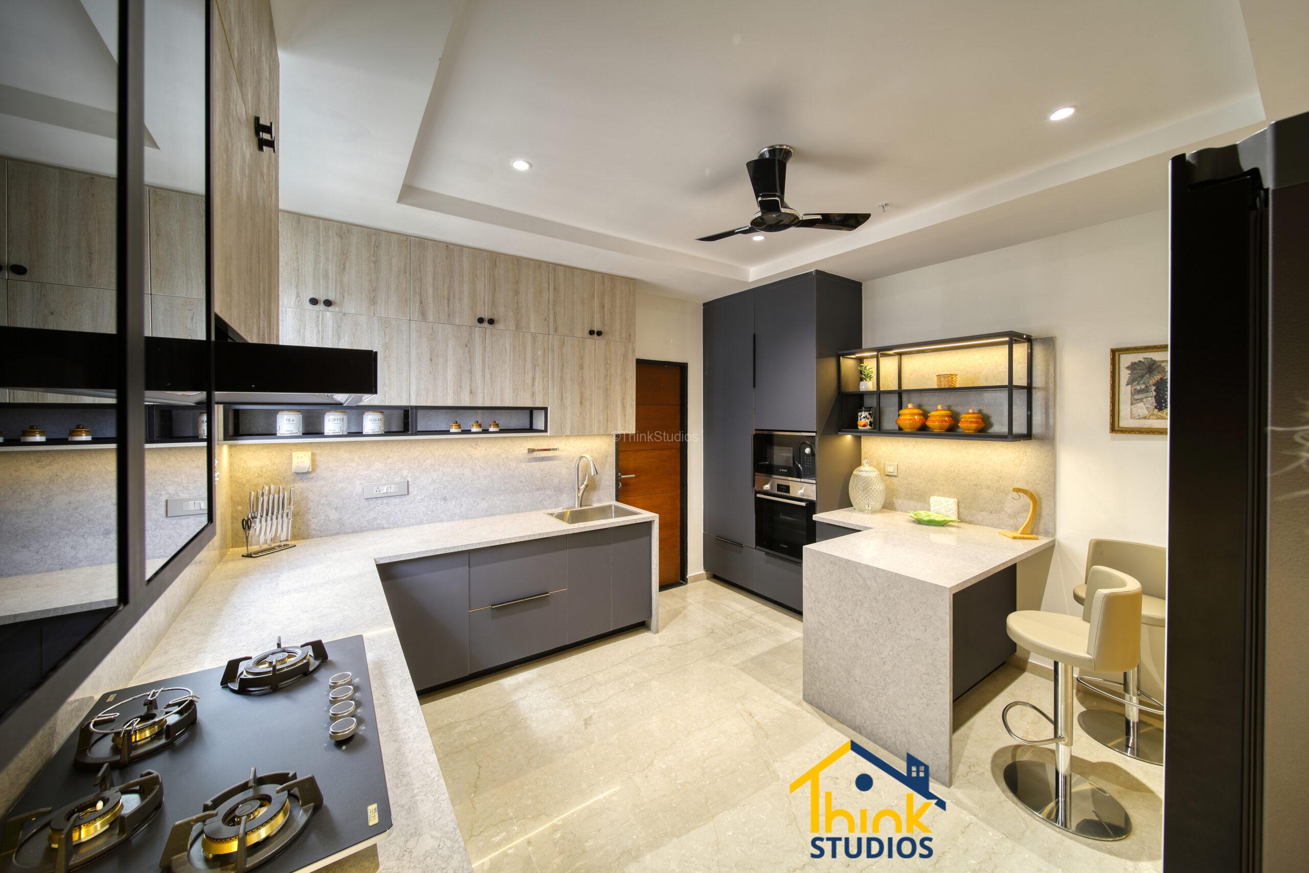 Luxury Kitchen with gray contrasting walls with beige cabinetry and integrated appliances