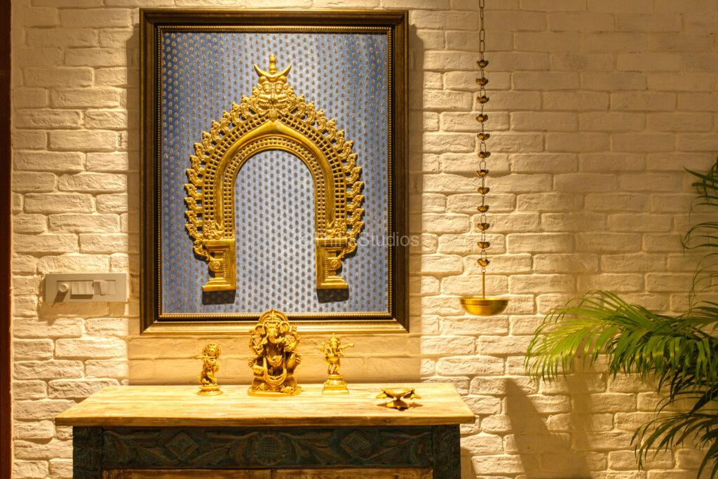 A traditional motif of brass on silk, framed a a beautiful dark wood.