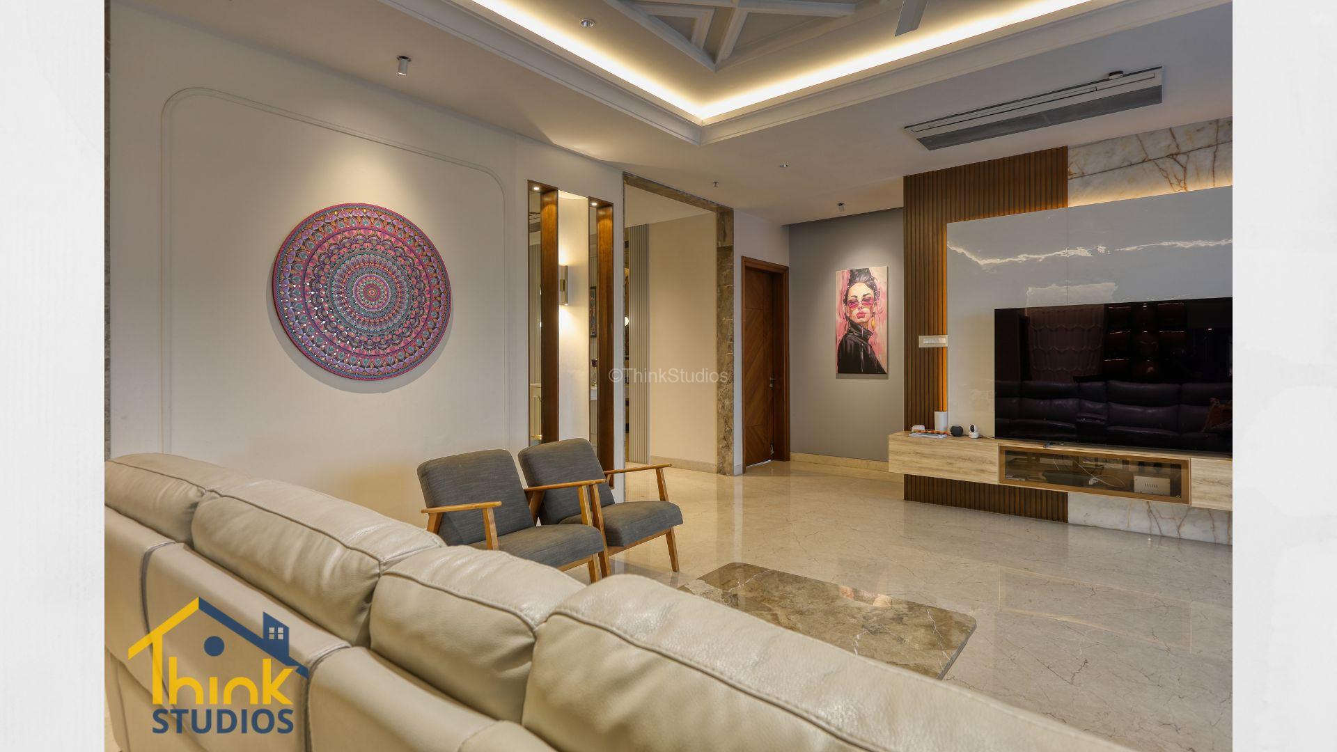 Luxury living room with large sofa and TV unit, with colourful art